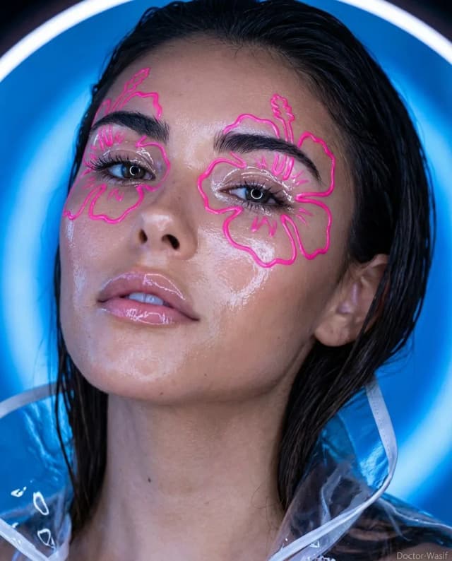 Glossy fashion editorial portrait with neon face paint and wet look hair.